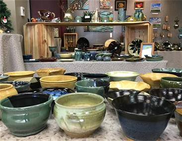 pottery and other artwork on display for purchase